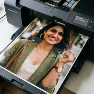 A digital photo printer printing a standard color glossy photograph of a woman on flat paper.