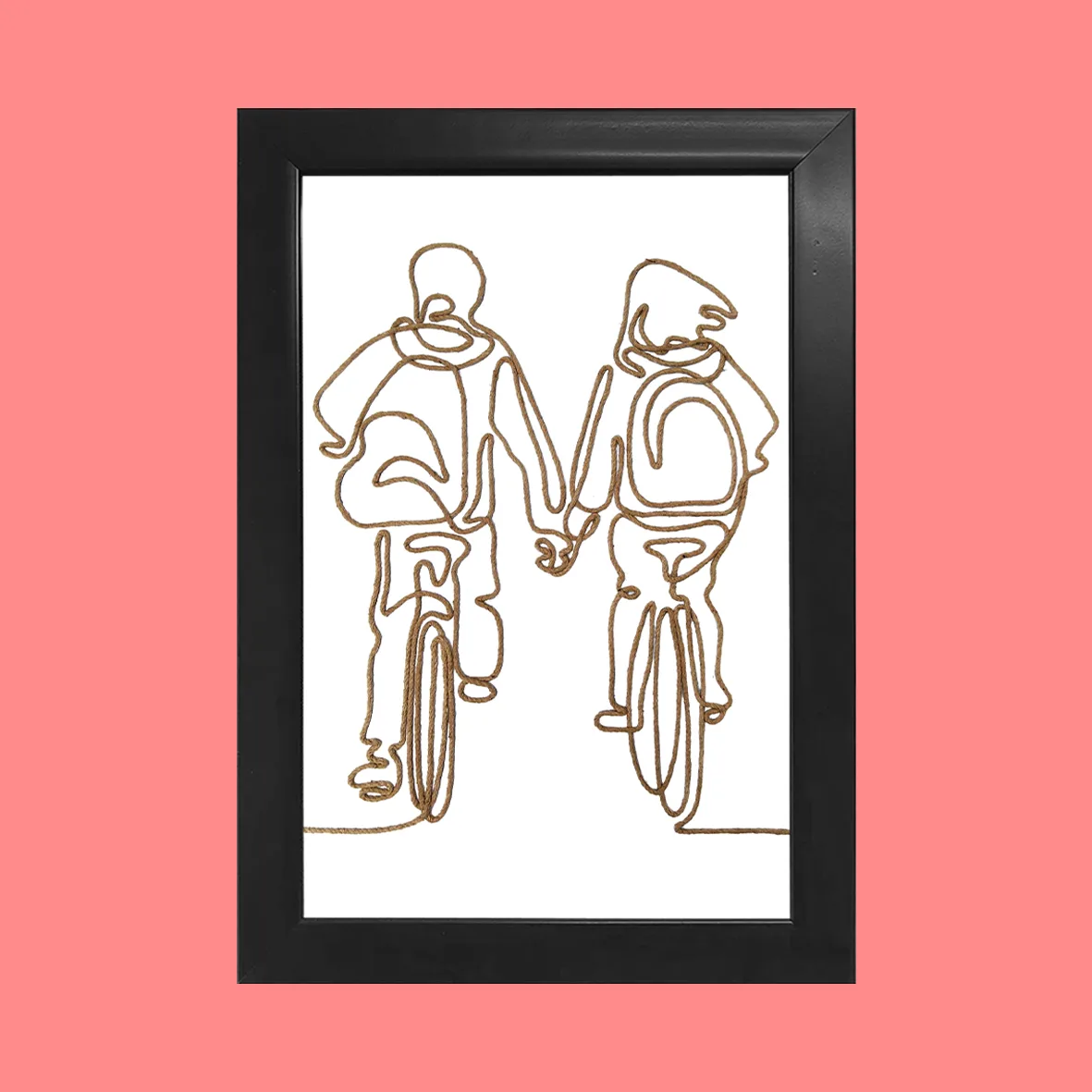A handcrafted rope line art of a couple cycling together, framed in black, with a pink background.