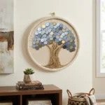 Premium boho-style living room setup featuring the Coin Tree Of Prosperity Handcrafted Round Wall Decor hung over a wooden cabinet with art books and a small plant.
