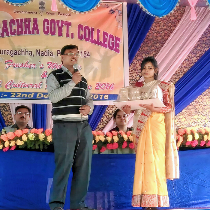 Hiya Biswas handing over the first handmade model of Muragachha Government College, created by Arnab Basu, to OIC Dr. Partha Karmakar during the 2016 Annual Cultural Program.