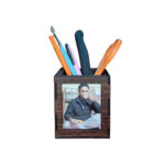 A dark brown MDF photo pen stand on a white background, displaying a custom photo of a man drinking tea or coffee. The stand is filled with pens, a paintbrush, and scissors. Ideal gift for men or office desk.