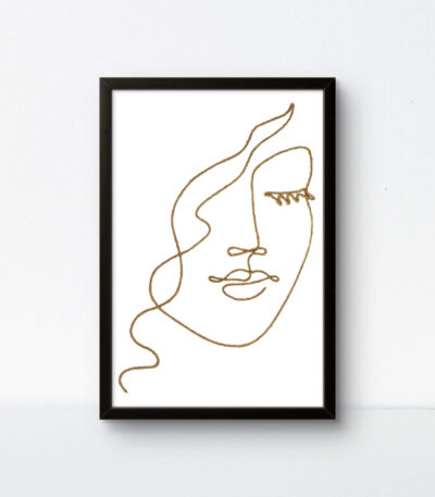 Handcrafted woman face string art with light background and black frame.