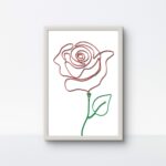 A handcrafted rose made of red and green rope, displayed in a clean white 9"x13" frame on a white background.