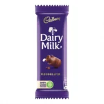 A vertical shot of a classic purple Cadbury Dairy Milk chocolate bar wrapper featuring the gold Cadbury logo, clinking milk glasses, and a tilted miniature clay pot pouring milk.