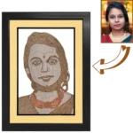 A personalized female rope craft portrait showing a realistic comparison arrow from the original photo of a woman in a saree to the handmade jute art featuring an orange beaded necklace, inside a black frame with a cream mount border.