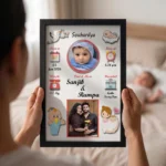 Close up real life shot of hands holding upahar18 personalized baby birth details classic photo frame design 001 with a blurred newborn baby sleeping in bed in the background