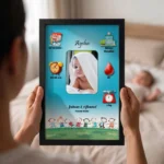 Close up real life shot of hands holding upahar18 personalized baby birth details classic photo frame design 007 with a blurred newborn baby sleeping in bed in the background