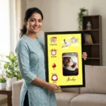 A smiling woman holding a personalized baby birth details classic photo frame design 009 by upahar18 inside a beautifully decorated home living room
