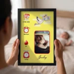 Close up real life shot of hands holding upahar18 personalized baby birth details classic photo frame design 009 with a blurred newborn baby sleeping in bed in the background