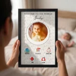 Close up real life shot of hands holding upahar18 personalized baby birth details classic photo frame design 015 with a blurred newborn baby sleeping in bed in the background