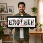 A smiling young man holding a large classic black Upahar18 Brother Photo Frame that showcases a custom-printed photo collage inside the word BROTHER with Rakhi greetings on a white background.