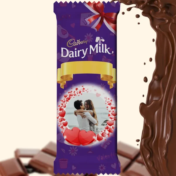 A personalized photo printed Cadbury Dairy Milk wrapper by upahar18, featuring a customized romantic couple photo surrounded by a heart-shaped frame and a gold ribbon design.