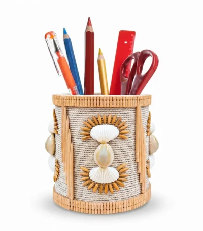 Studio shot of Upahar18 Handmade Eco-Friendly Rope Base Pen Stand on a clean white background. The desk organiser holds colorful pencils, a red ruler, and scissors, highlighting the intricate detail of the woven rope structure, cowrie shells, and delicate bamboo trims.
