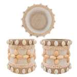 Multi-angle showcase of Upahar18 Handmade Eco-Friendly Rope Base Pen Stand with Cowrie Shells. The overhead shot reveals a deep, spiral rope cavity, while the two lower profiles show the symmetrical and continuous wrapping of cowrie shells and wooden seed flowers all around the desk organiser.
