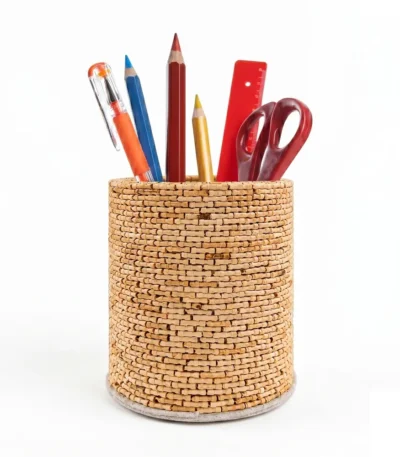 A multi-angle product feature of the Upahar18 handmade textured pen stand. The upper circular image presents a birds-eye view inside the stand showing a spiral-coiled rope base encircled by natural wooden sticks, while the lower panel displays two matching woven pen holders side-by-side on a white backdrop.