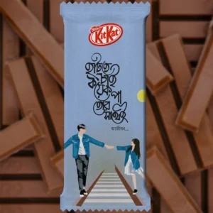 A pre-designed light blue chocolate wrapper featuring a soulful Bengali Quote that says "Hatate Chai Koyek Pa Tor Sathei." This Romantic themed KitKat design showcases a minimalist couple illustration walking on a railway track, capturing a nostalgic and sweet moment.