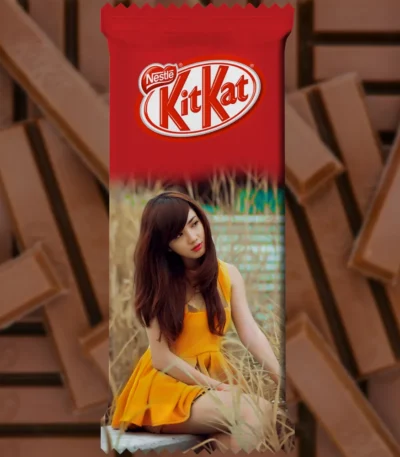 A vertical upahar18 personalized chocolate wrapper for a kitkat bar, showing a customized photo printed portrait of a woman in a yellow dress sitting among tall dry grass.