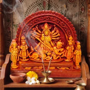 Upahar18 handcrafted Terracotta Maa Durga Devi idol placed in a home temple setup with burning incense sticks, flowers, and a diya, crafted by traditional artisans of Krishnanagar.