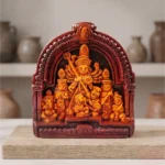 Authentic dark-shaded Terracotta Maa Durga idol by upahar18 displayed elegantly on a block of wood inside a decor studio backdrop, crafted in Krishnanagar.