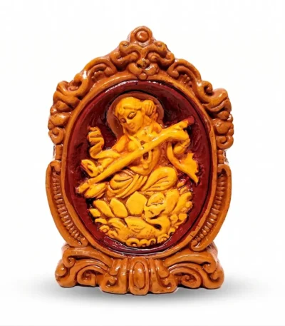 Premium upahar18 handcrafted Terracotta Maa Saraswati idol holding a Veena in a decorative frame, crafted by heritage clay artisans of Krishnanagar.