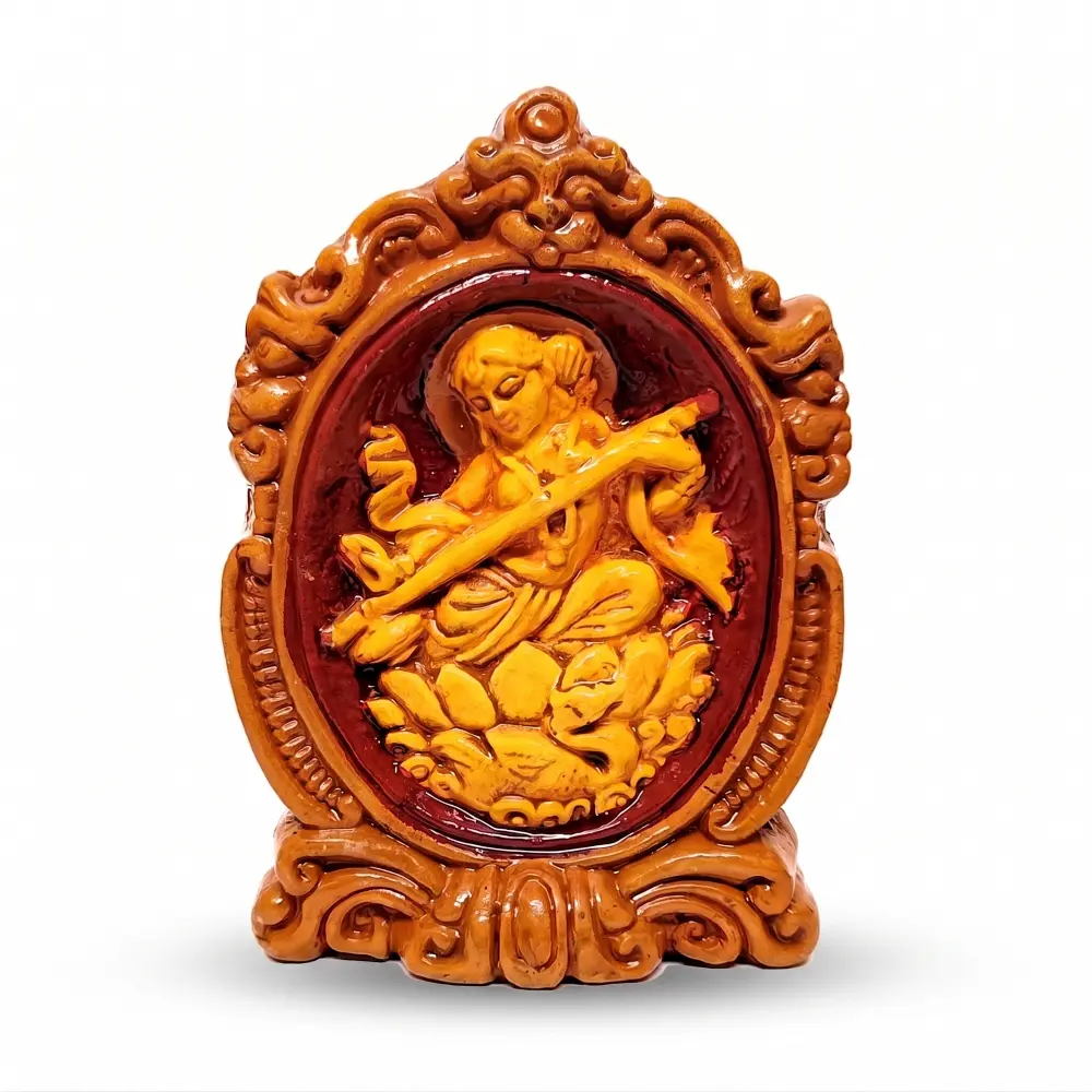 Premium upahar18 handcrafted Terracotta Maa Saraswati idol holding a Veena in a decorative frame, crafted by heritage clay artisans of Krishnanagar.