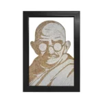 Upahar18 Mahatma Gandhi Rope Craft Portrait Frame enclosed in a sleek black rectangle border showcasing a handmade portrait of Mahatma Gandhi wearing his shawl, crafted with jute and cotton ropes.