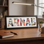 A classic black rectangular Upahar18 NAME Photo Frame with a custom photo collage printed inside the name ARNAB, neatly sitting on a wooden study table next to a notebook, pen, and desk lamp.