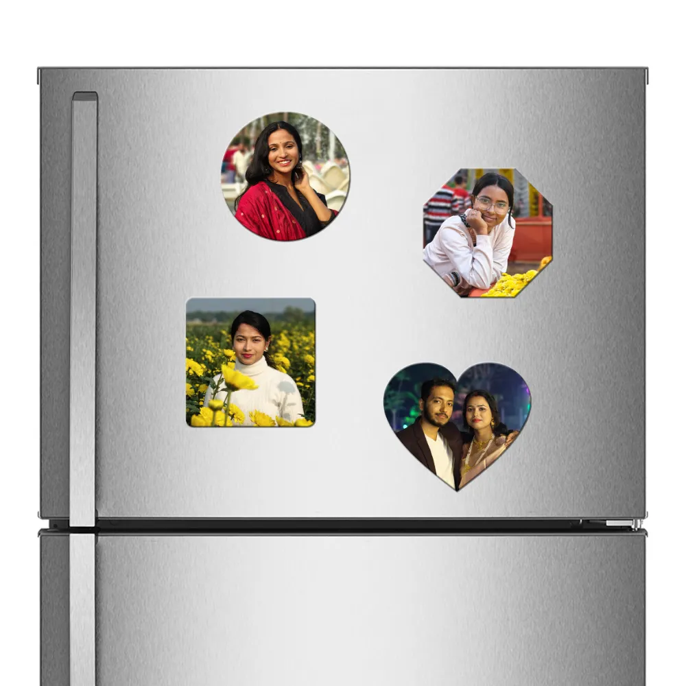A straight front view of a stainless steel refrigerator door decorated with a combo set of four different shaped custom flexible photo fridge magnets, including a round magnet showing a woman in a red dupatta, an octagon magnet showing a woman with glasses resting her chin on her hand, a square magnet with a woman in a yellow mustard field, and a heart-shaped magnet displaying an Indian couple smiling together at night, all featuring vibrant personalized photos by upahar18.