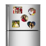 A straight front view of a metallic double-door refrigerator holding a complete combo pack of five different shaped personalized flexible photo printed fridge magnets, which includes a landscape rectangle magnet featuring a traditional Indian bride and groom, an octagon magnet, a center round magnet, a square magnet in a mustard field, and a heart-shaped couple magnet, all showcasing customized high-definition photos by upahar18.