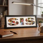 A classic black rectangular Upahar18 Sister Photo Frame with a custom photo collage printed inside the word SIS, neatly sitting on a wooden study table next to a notebook, pen, and desk lamp.