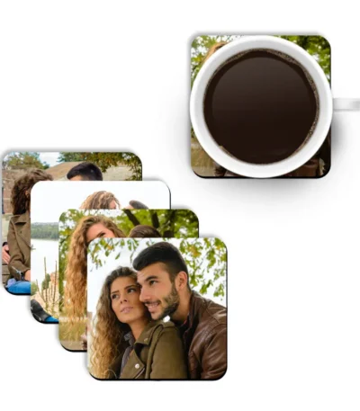 A 2x2 grid display of four individual square-shaped MDF coasters by upahar18, each highlighting a different high-quality printed photo of a young couple outdoors.
