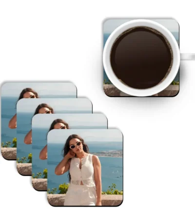 A top-down mockup layout showing a white mug filled with hot black coffee placed next to a diagonal stack of four square MDF coasters from upahar18 printed with a personalized custom photo of a woman by the sea.
