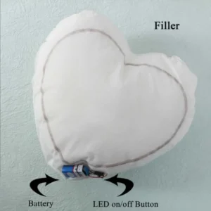 A technical product layout displaying the inner heart-shaped cushion filler with an attached battery link and LED switch by upahar18.