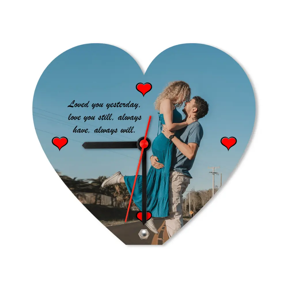 A studio front view of a white-background isolated heart-shaped upahar18 Table clock printed with a custom photo of a couple and a romantic message.