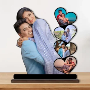 A vibrant personalized custom photo printed MDF cutout standee by upahar18 of a romantic couple's heart collage, beautifully displayed on a premium wooden tabletop surface against a neutral wall backdrop.