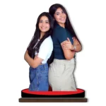 A personalized custom photo printed MDF cutout standee from upahar18 showcasing two smiling female friends standing back-to-back with arms crossed, isolated on a plain white background.