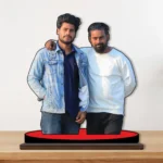 A high-quality printed MDF cutout standee by upahar18 featuring a personalized custom photo of two male friends standing shoulder-to-shoulder on a round red base over a smooth wooden surface.