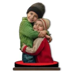 A high-definition personalized custom photo printed MDF cutout standee from upahar18 showcasing two happy kids hugging in winter beanies and sweaters, isolated on a clean white background.