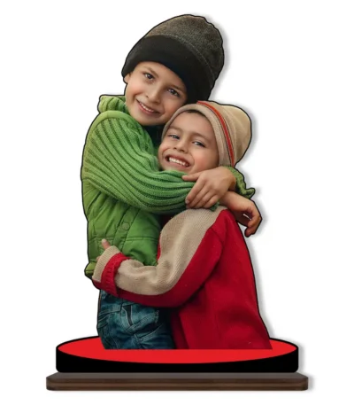 A high-definition personalized custom photo printed MDF cutout standee from upahar18 showcasing two happy kids hugging in winter beanies and sweaters, isolated on a clean white background.