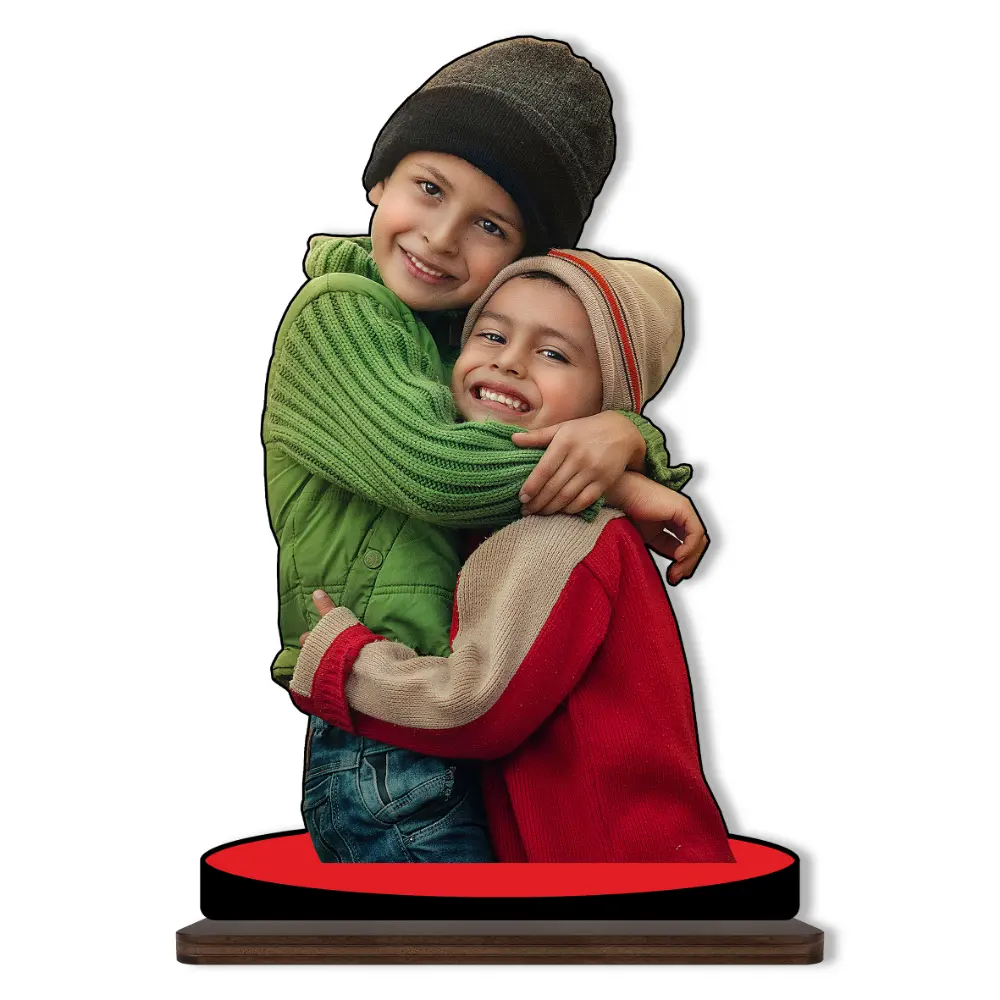A high-definition personalized custom photo printed MDF cutout standee from upahar18 showcasing two happy kids hugging in winter beanies and sweaters, isolated on a clean white background.