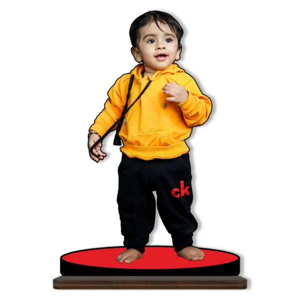 A cute personalized custom photo printed MDF cutout standee from upahar18 featuring a small toddler boy wearing a bright yellow hoodie and black sweatpants, isolated on a solid white background.