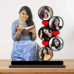 A vibrant personalized custom photo printed MDF cutout standee by upahar18 of a multi-photo round collage, displayed beautifully on a smooth wooden tabletop surface against a plain light wall.