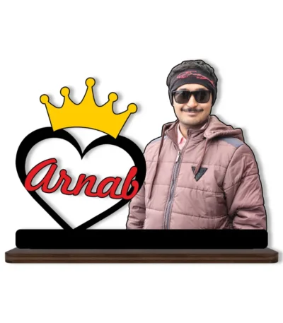 A high-definition printed MDF cutout standee by upahar18 featuring a personalized custom photo of a man next to a large black-bordered heart with a golden royal crown on top and the name "Arnab" printed inside in red, isolated on a white background.