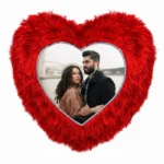 A close-up product shot of a personalized red heart-shaped fur cushion featuring a printed couple's custom photo from upahar18.