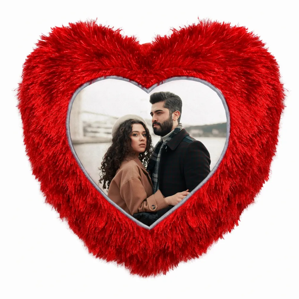 A close-up product shot of a personalized red heart-shaped fur cushion featuring a printed couple's custom photo from upahar18.
