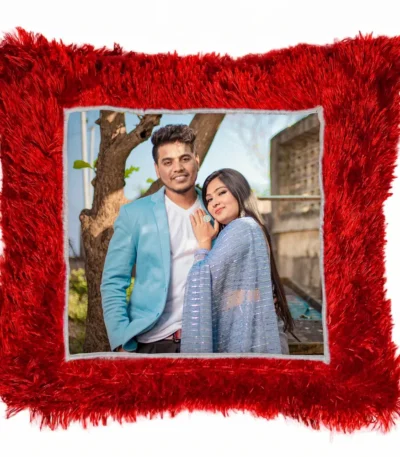 A high-definition product shot of a personalized red square-shaped fur cushion featuring a custom photo of a couple by a tree from upahar18.