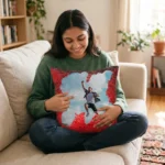 A smiling woman sitting on a sofa and interacting with a personalized red square custom photo magic cushion by upahar18.