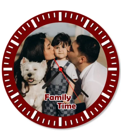 A crisp studio front view of a circular upahar18 Wall clock printed with a high-definition custom photo of a mother and father kissing their child alongside a white pet dog, isolated on a solid white background.