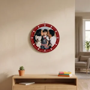 A round-shaped MDF clock from upahar18 hanging on a beige living room wall above a wooden console cabinet, featuring a printed custom photo of a family with their pet dog and "Family Time" text.
