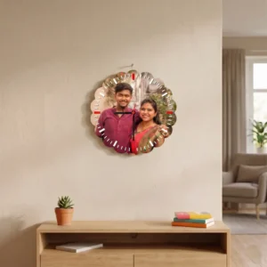 A flower-shaped wavy edge MDF clock from upahar18 hanging on a beige living room wall, displaying a printed custom photo of a smiling couple in traditional attire.